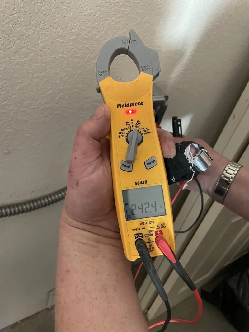 Voltage testing with clamp meter during Whole House Surge Protector in Norfolk